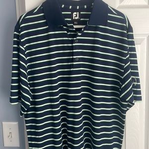 Footjoy golf shirt with stock wood country club logo on sleeve.